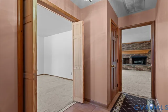 a dining room with furniture potted plants and wooden floor