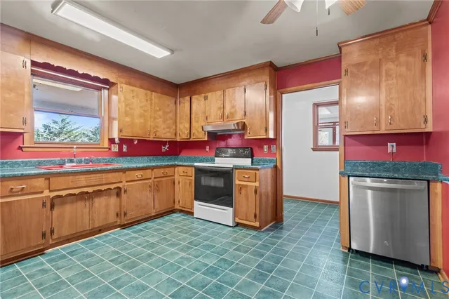 a view of an empty room with a fireplace and a window