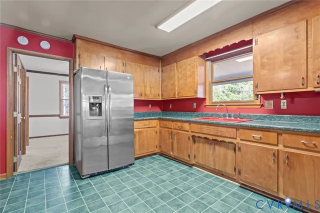 a view of an empty room with a window and a fireplace