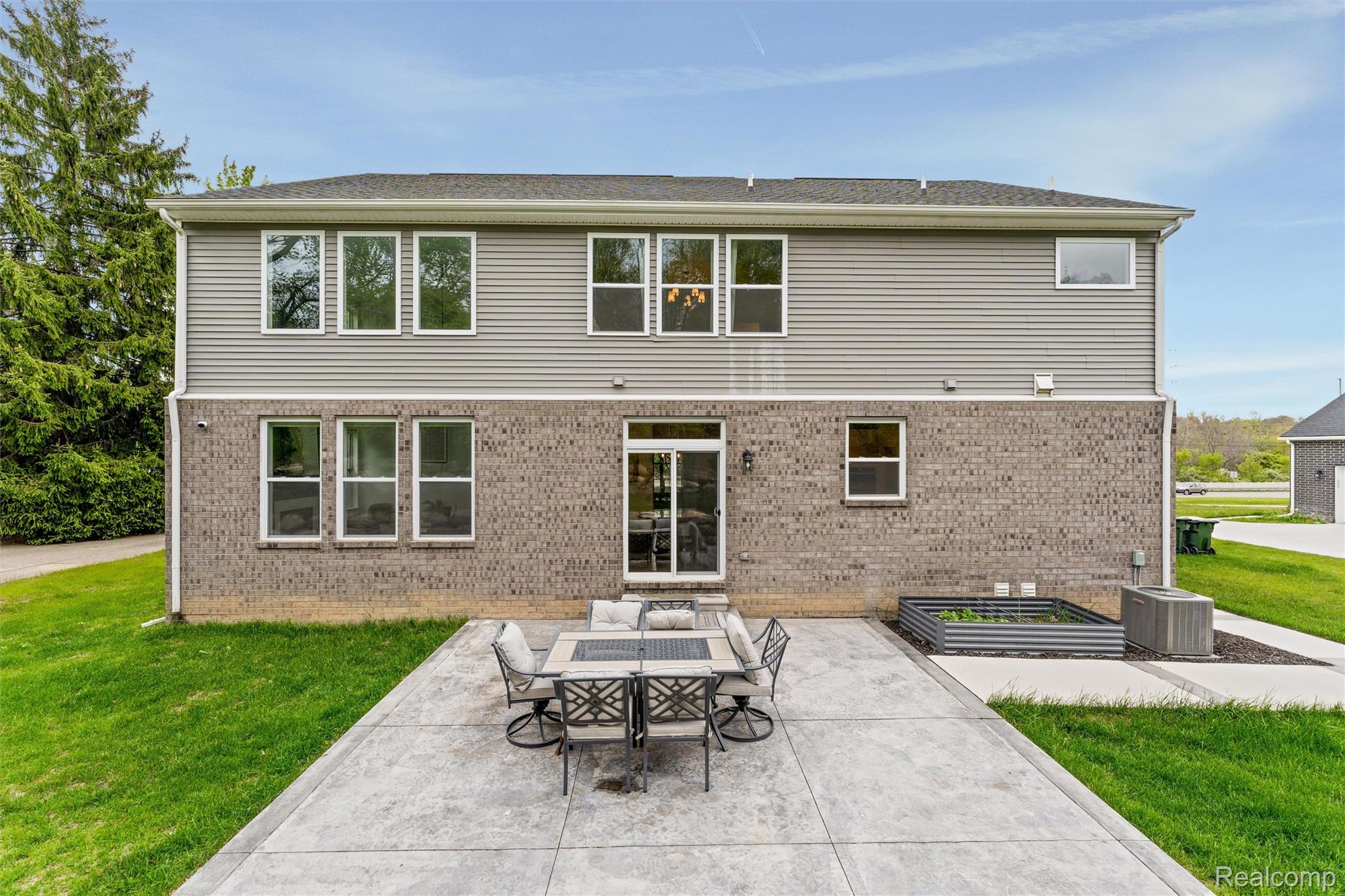 908 South Livernois Road Rochester, MI 48309 - Photo 48 of 49 Rear view of house featuring a lawn, brick siding, a patio, and outdoor dining area