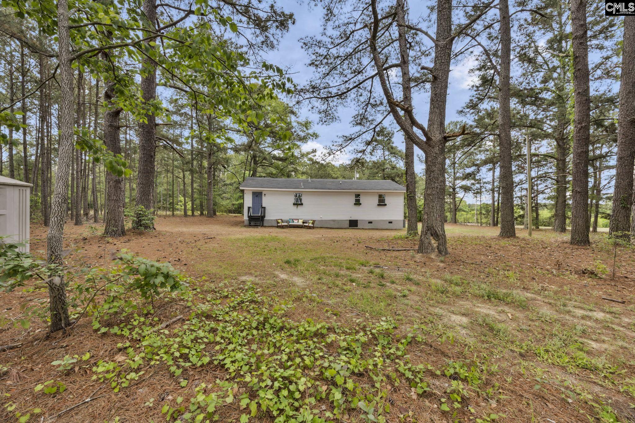 8107 Black River Road Rembert, SC 29128 - Photo 33 of 38 a view of a house with a yard and tree s