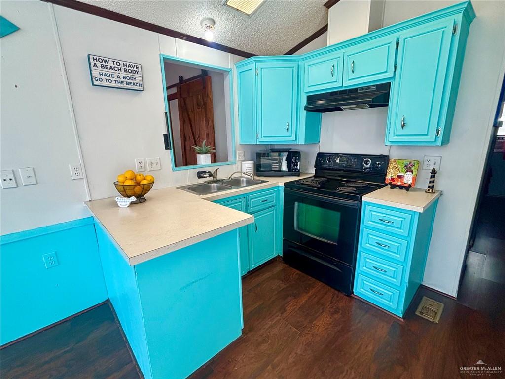 513 West Clam Circle Port Isabel, TX 78578 - Photo 11 of 37 a kitchen with granite countertop a sink cabinets and stainless steel appliances