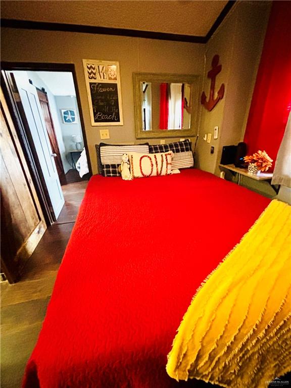 513 West Clam Circle Port Isabel, TX 78578 - Photo 16 of 37 a bed room with a bed and a couch