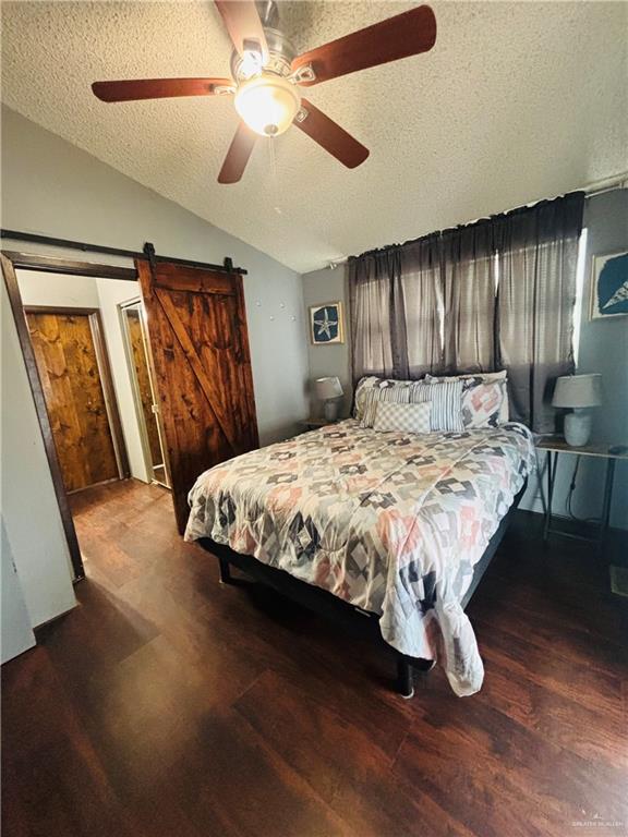 513 West Clam Circle Port Isabel, TX 78578 - Photo 17 of 37 a bedroom with a large bed and a chandelier