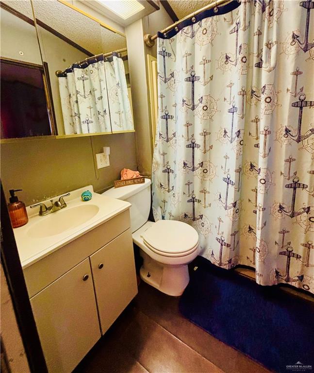 513 West Clam Circle Port Isabel, TX 78578 - Photo 18 of 37 a bathroom with a toilet sink and shower