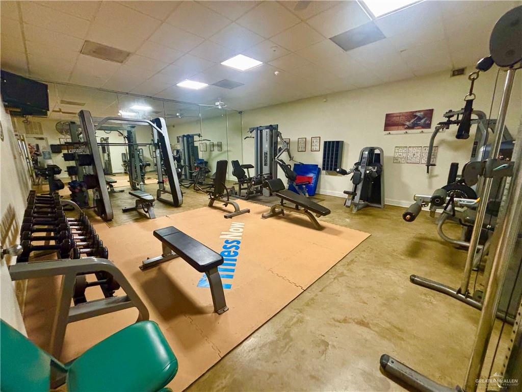 513 West Clam Circle Port Isabel, TX 78578 - Photo 33 of 37 a room with gym equipment and a mirror