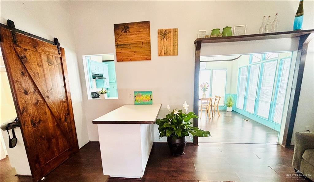 513 West Clam Circle Port Isabel, TX 78578 - Photo 6 of 37 a view of a hallway with wooden floor and stairs