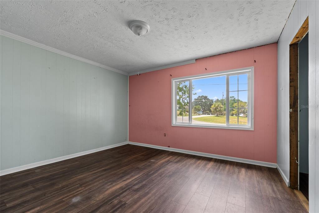 330 West 4th Street Frostproof, FL 33843 - Photo 13 of 39 an empty room with wooden floor and windows