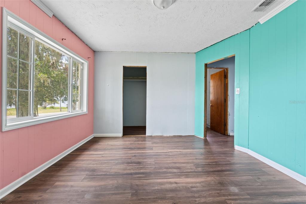 330 West 4th Street Frostproof, FL 33843 - Photo 15 of 39 a view of an empty room with wooden floor and a window
