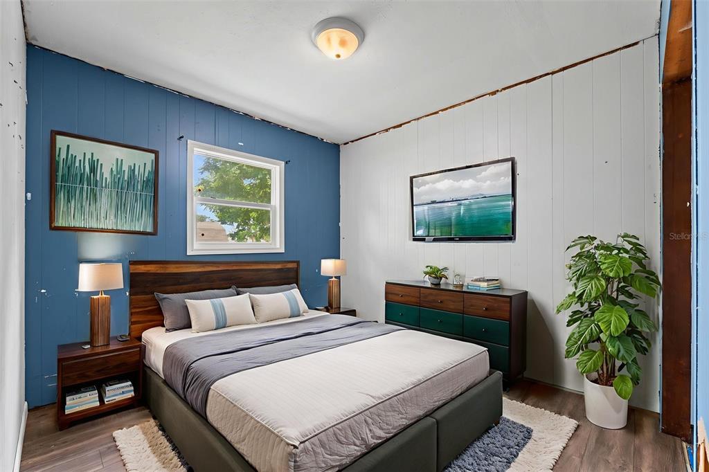 330 West 4th Street Frostproof, FL 33843 - Photo 19 of 39 a bedroom with a bed and a flat screen tv