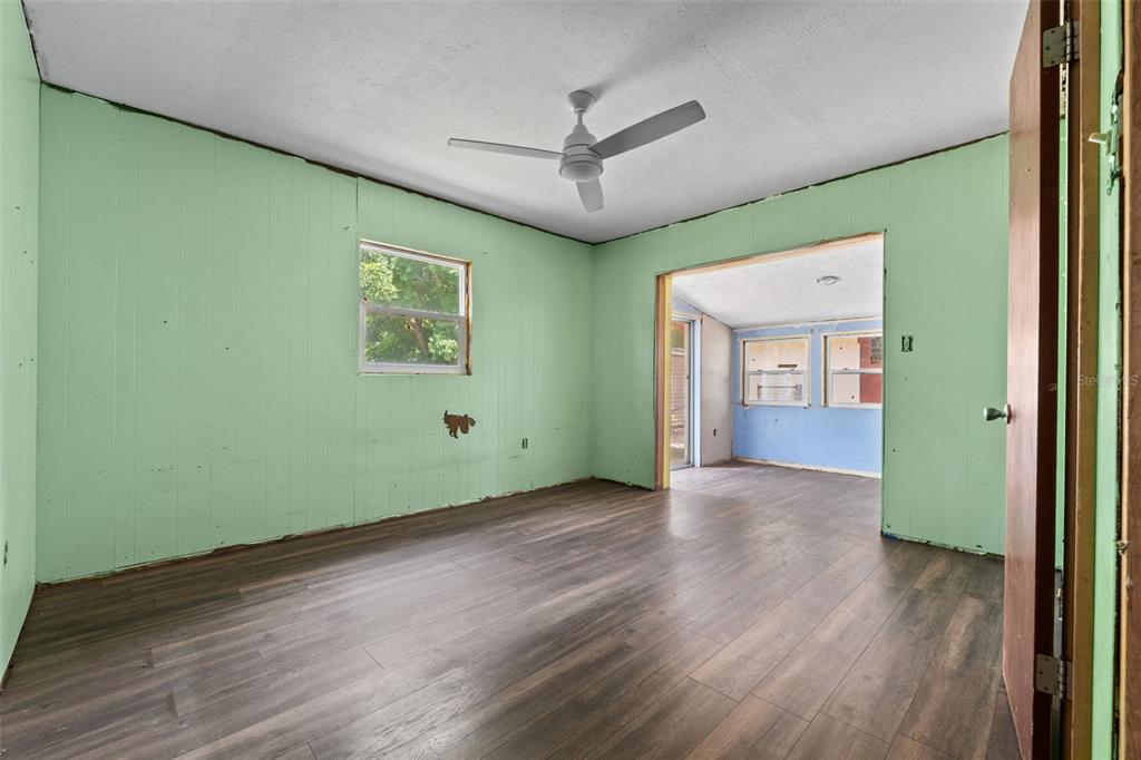 330 West 4th Street Frostproof, FL 33843 - Photo 20 of 39 an empty room with wooden floor and windows