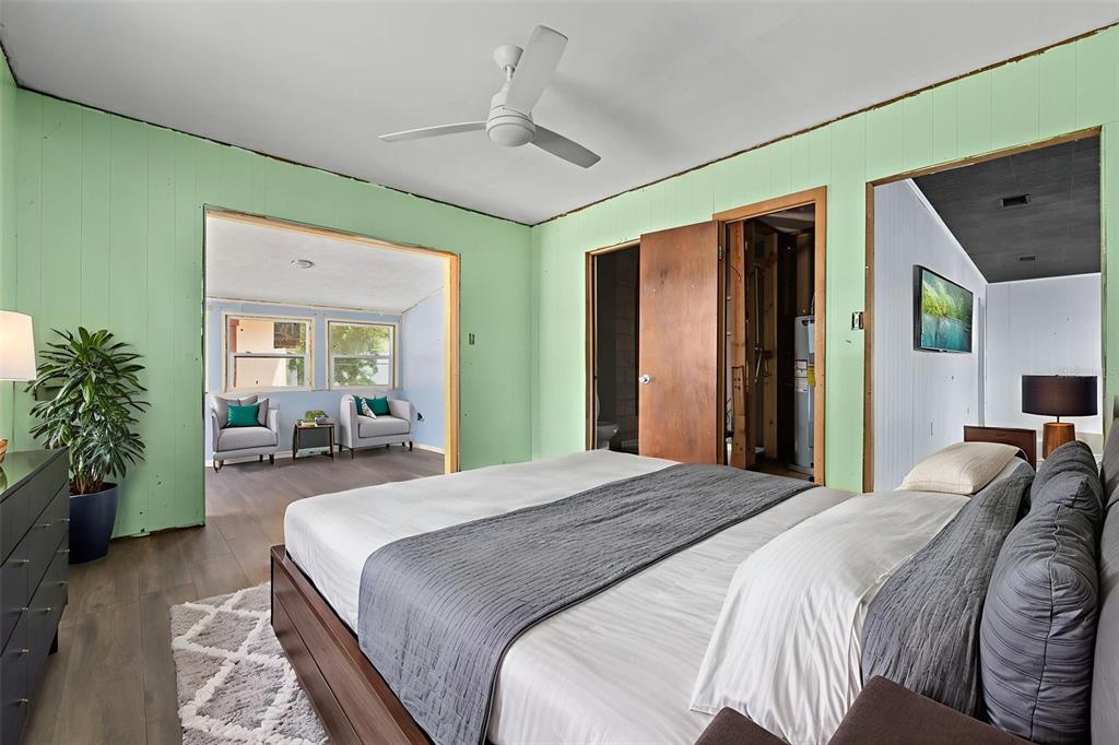 330 West 4th Street Frostproof, FL 33843 - Photo 22 of 39 a spacious bedroom with a bed and a potted plant