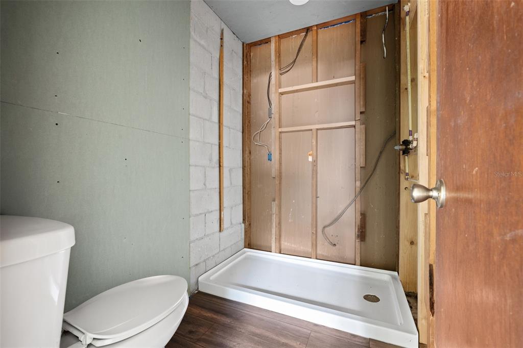 330 West 4th Street Frostproof, FL 33843 - Photo 23 of 39 a bathroom with a tub and toilet