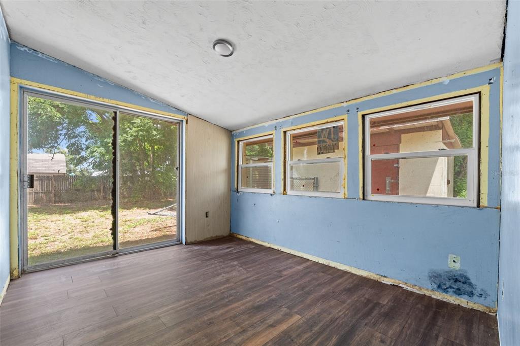 330 West 4th Street Frostproof, FL 33843 - Photo 24 of 39 a view of an empty room with wooden floor and windows