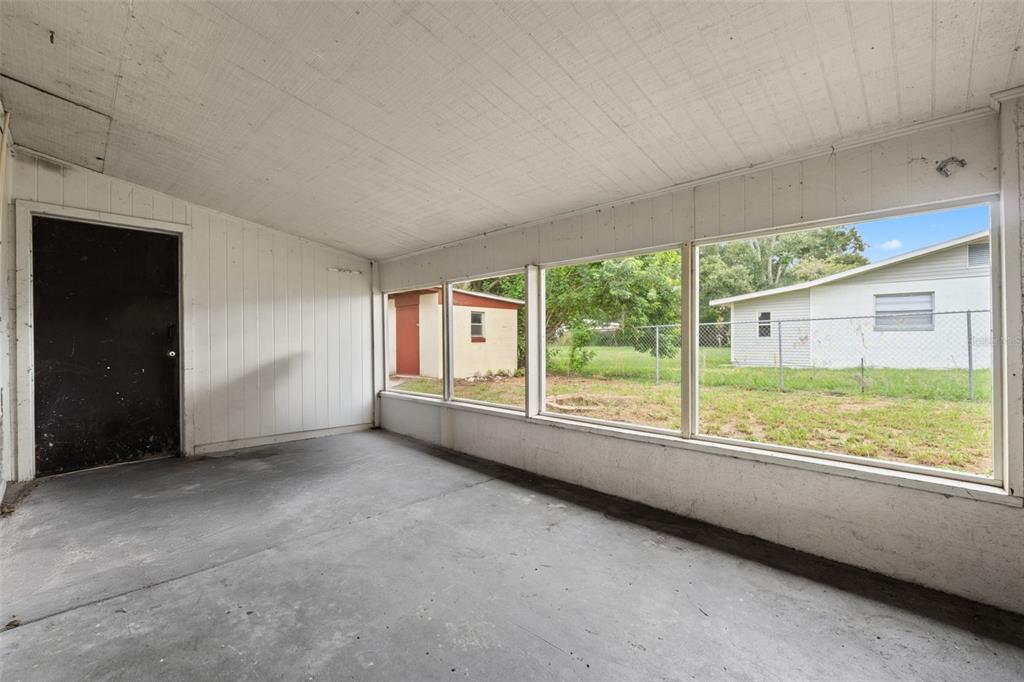 330 West 4th Street Frostproof, FL 33843 - Photo 29 of 39 an empty room with large windows and outdoor view