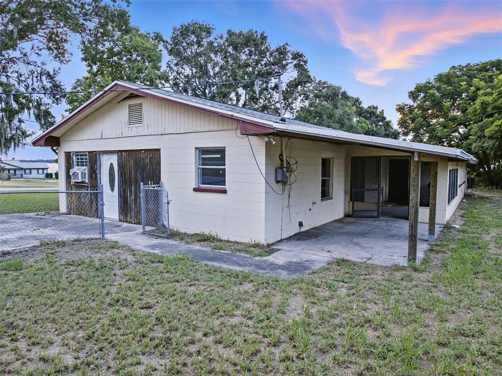 330 West 4th Street Frostproof, FL 33843 - Photo 32 of 39 a view of a house with yard and a garden
