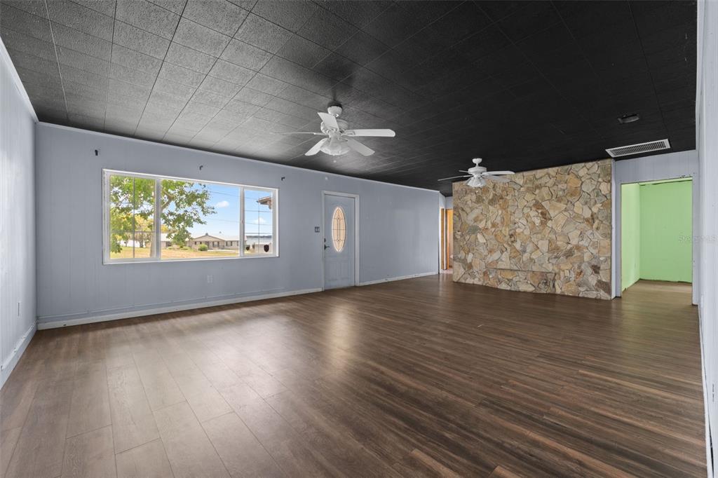 330 West 4th Street Frostproof, FL 33843 - Photo 4 of 39 wooden floor in an empty room with a window