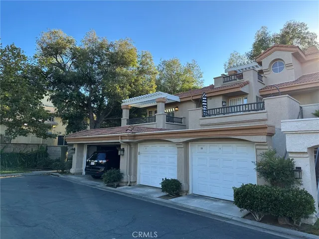 a view of house with outdoor space and parking