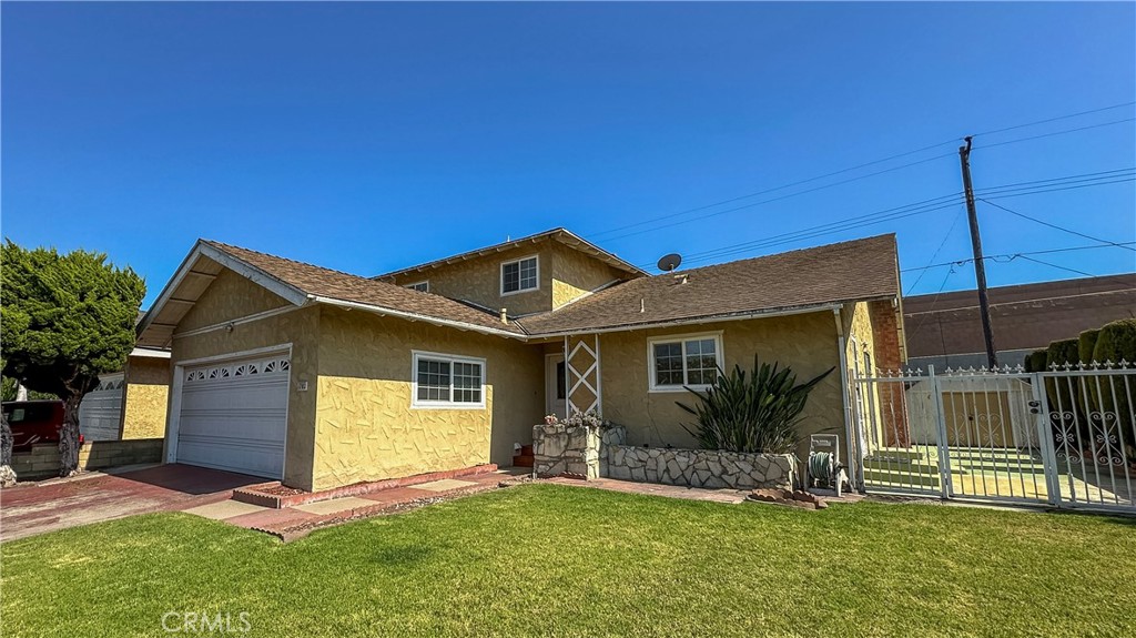 1702 East Bach Street Carson, CA 90745 - Photo 16 of 48 a view of a house with a yard potted plants and a table