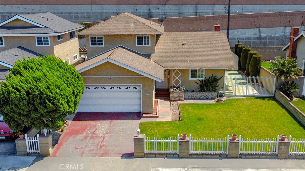 1702 East Bach Street Carson, CA 90745 - Photo 3 of 48 a front view of a house with a garden