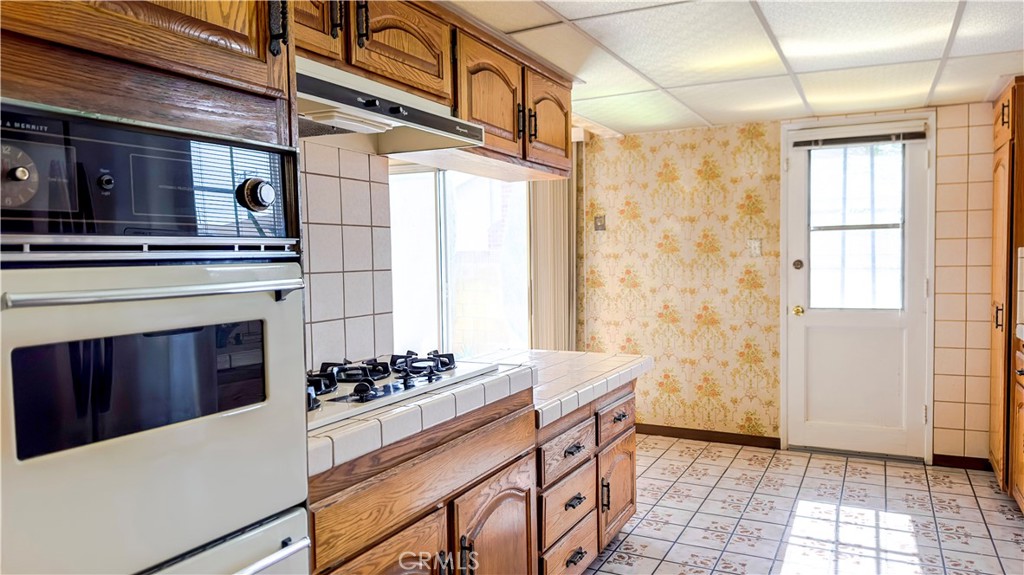 1702 East Bach Street Carson, CA 90745 - Photo 35 of 48 a kitchen with stainless steel appliances a refrigerator and a stove