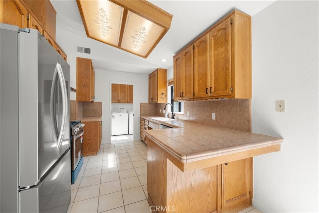 836 Casals Drive Paso Robles, CA 93446 - Photo 12 of 33 a kitchen with stainless steel appliances granite countertop a refrigerator a stove and a sink