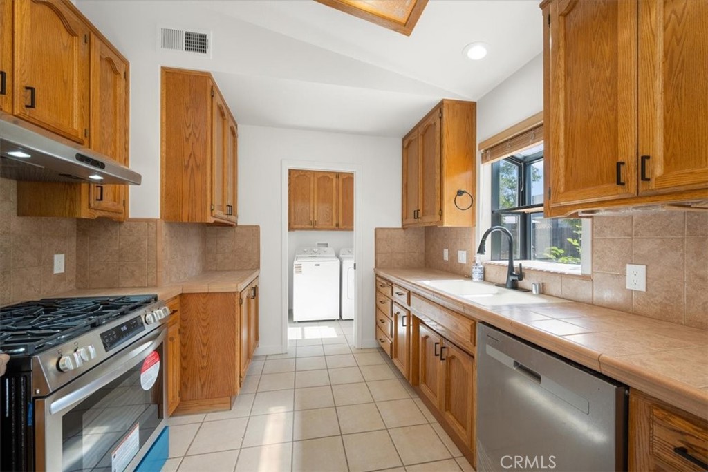836 Casals Drive Paso Robles, CA 93446 - Photo 13 of 33 a kitchen with stainless steel appliances granite countertop a stove a sink and a microwave