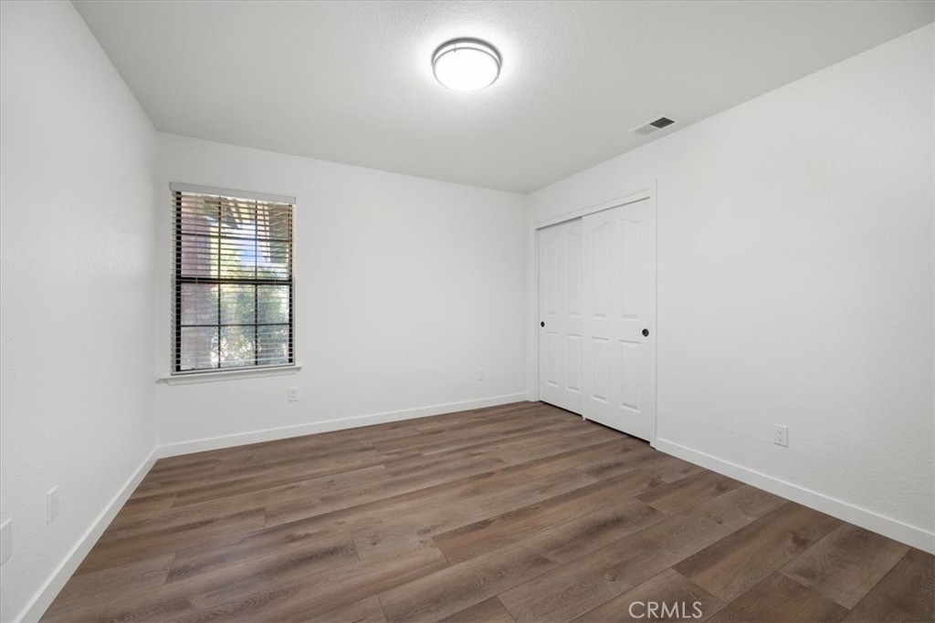 836 Casals Drive Paso Robles, CA 93446 - Photo 21 of 33 an empty room with wooden floor and windows