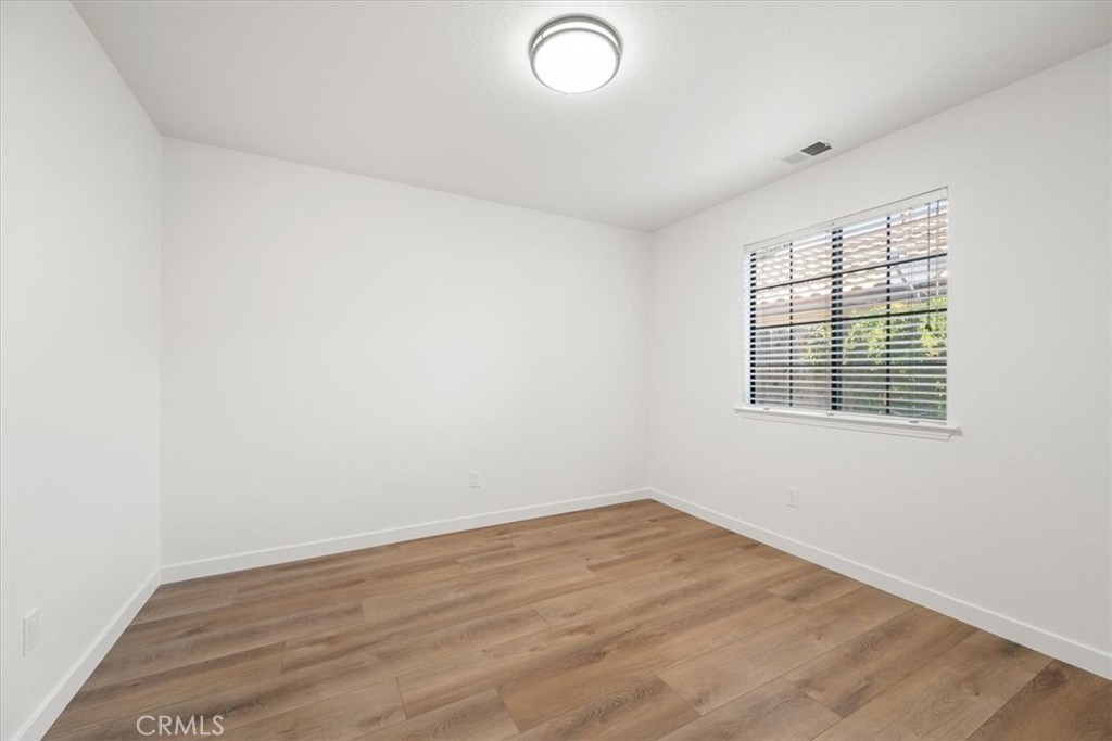 836 Casals Drive Paso Robles, CA 93446 - Photo 23 of 33 an empty room with wooden floor and windows