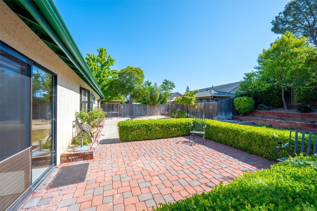836 Casals Drive Paso Robles, CA 93446 - Photo 27 of 33 a view of a backyard with potted plants and a large tree