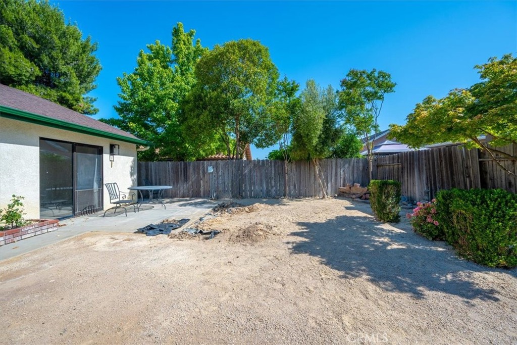 836 Casals Drive Paso Robles, CA 93446 - Photo 32 of 33 a view of a backyard with a large tree and wooden fence