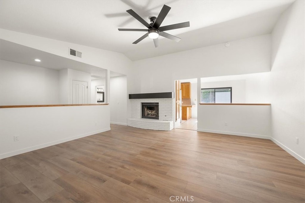 836 Casals Drive Paso Robles, CA 93446 - Photo 10 of 33 a view of a livingroom with a fireplace a ceiling fan and wooden floor