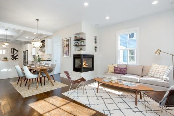 a living room with furniture a fireplace and a table