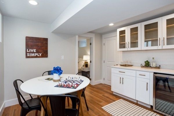 a kitchen with stainless steel appliances granite countertop a dining table and chairs