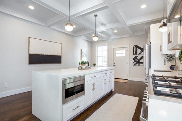 a kitchen with stainless steel appliances a stove a sink and a refrigerator