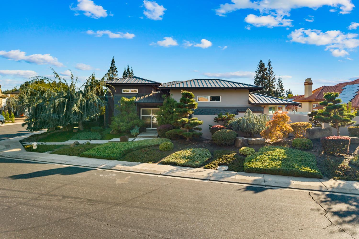 7434 River Nine Drive Modesto, CA 95356 - Photo 12 of 56 a front view of a house with a yard and potted plants