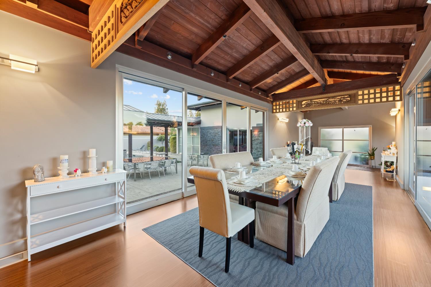 7434 River Nine Drive Modesto, CA 95356 - Photo 18 of 56 a dining room with furniture a chandelier and wooden floor