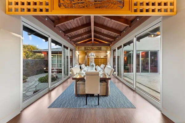 a dining room with furniture wooden floor and a potted plant