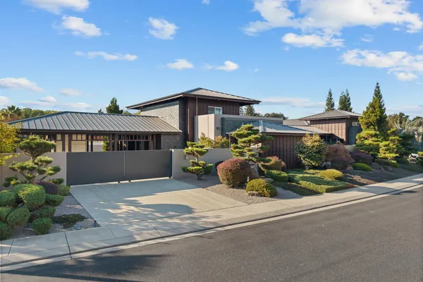 a front view of a house with a yard and outdoor seating