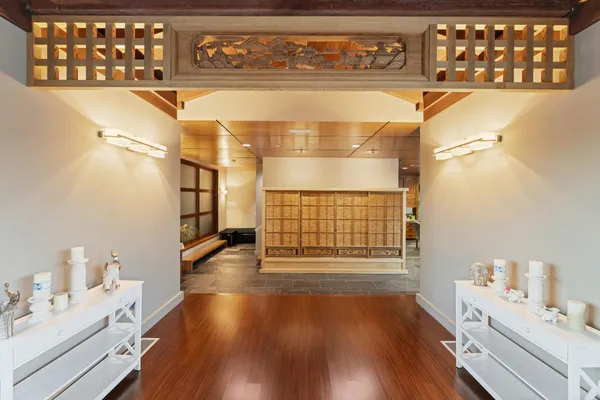 a view of entryway and hall with wooden floor