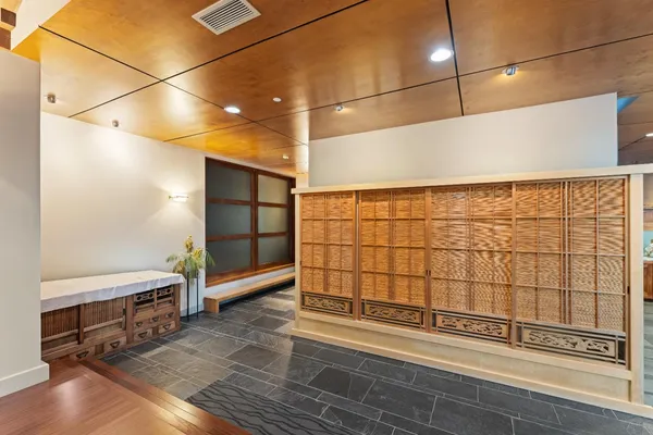 a view of entryway and hall with wooden floor