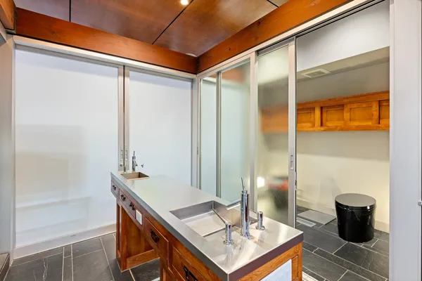 a view of a dining room with furniture and a chandelier