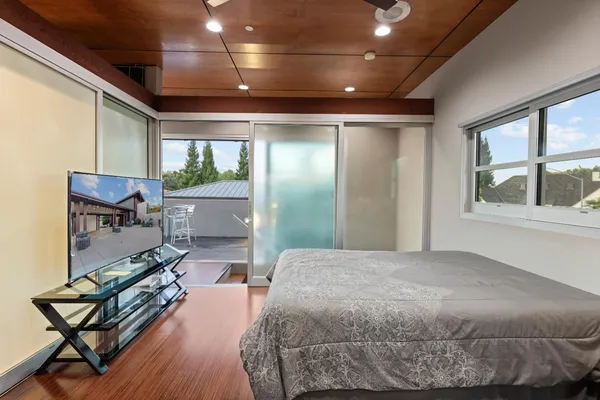 a dining room with furniture and a floor to ceiling window
