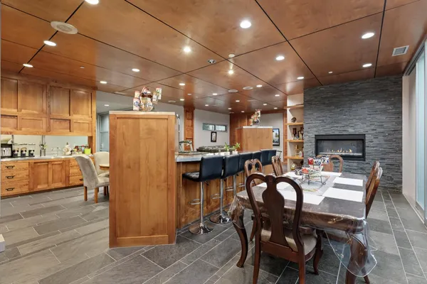 a kitchen that has a lot of cabinets in it and wooden cabinets