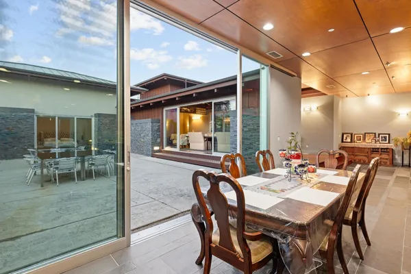 a kitchen with stainless steel appliances kitchen island granite countertop a dining table and chairs