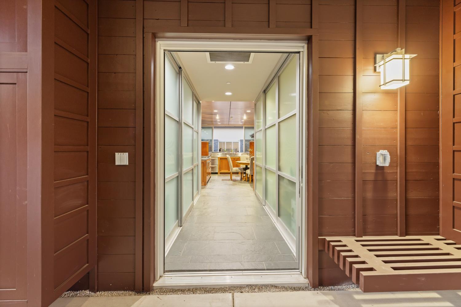 7434 River Nine Drive Modesto, CA 95356 - Photo 40 of 56 a view of a hallway with wooden floor and a living room