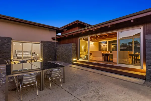 a backyard of a house with a fountain