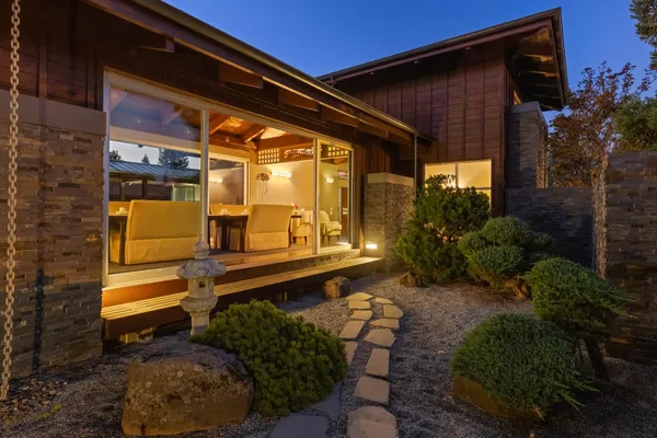 a view of a house with a yard and sitting area