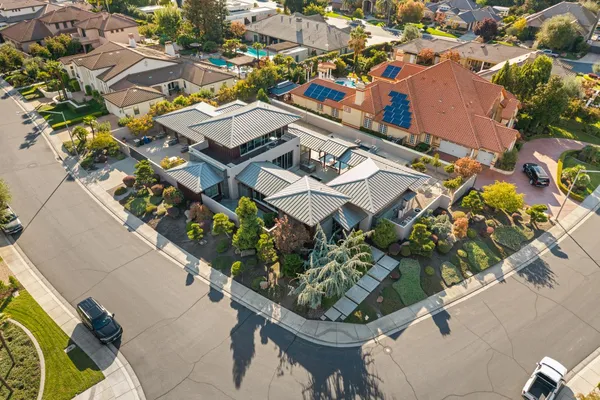 an aerial view of multiple houses with a yard