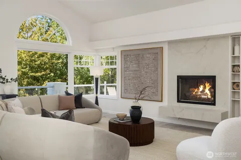 a living room with furniture and a floor to ceiling window